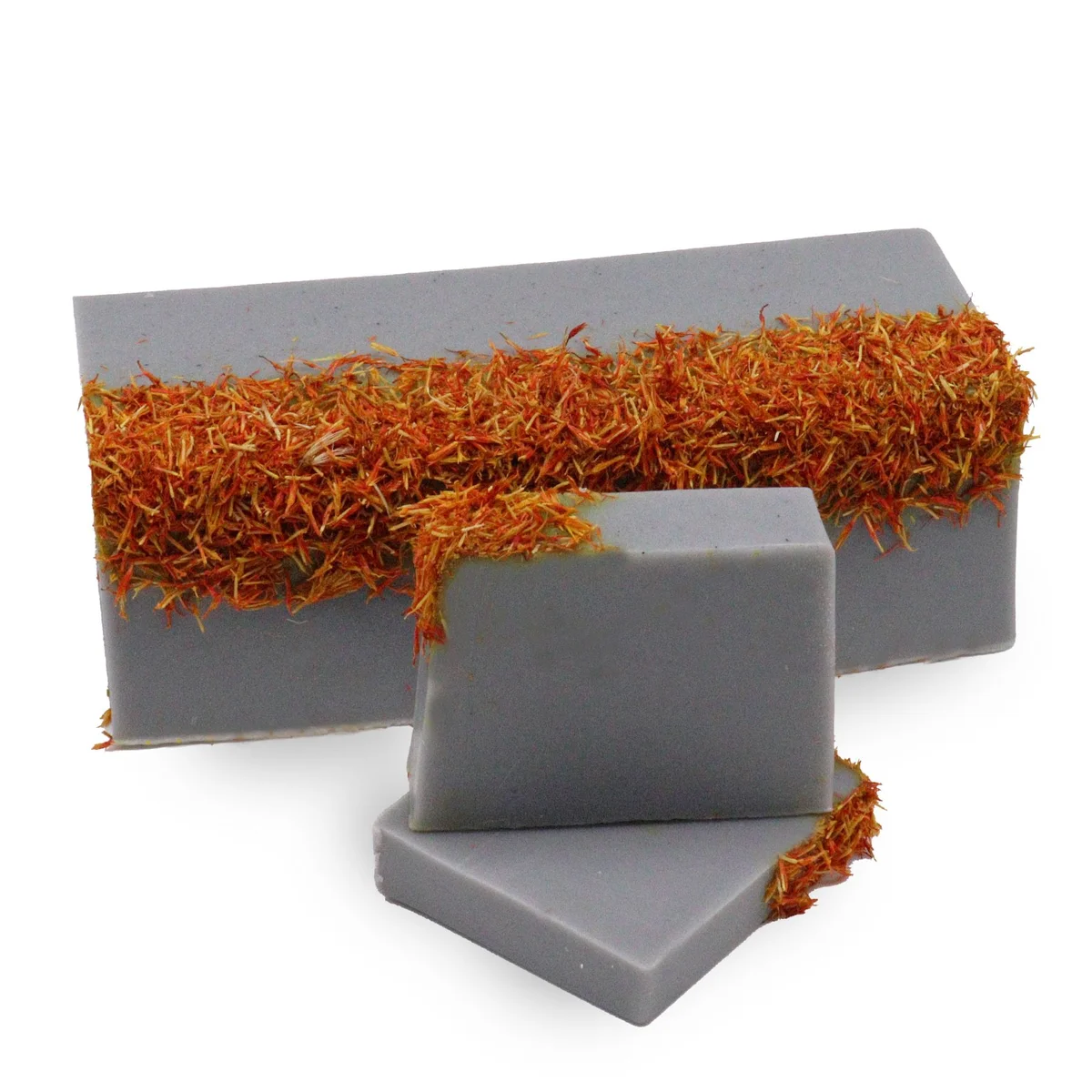 Coastal wilderness soap loaf with natural textured surface and earthy tones on a white background