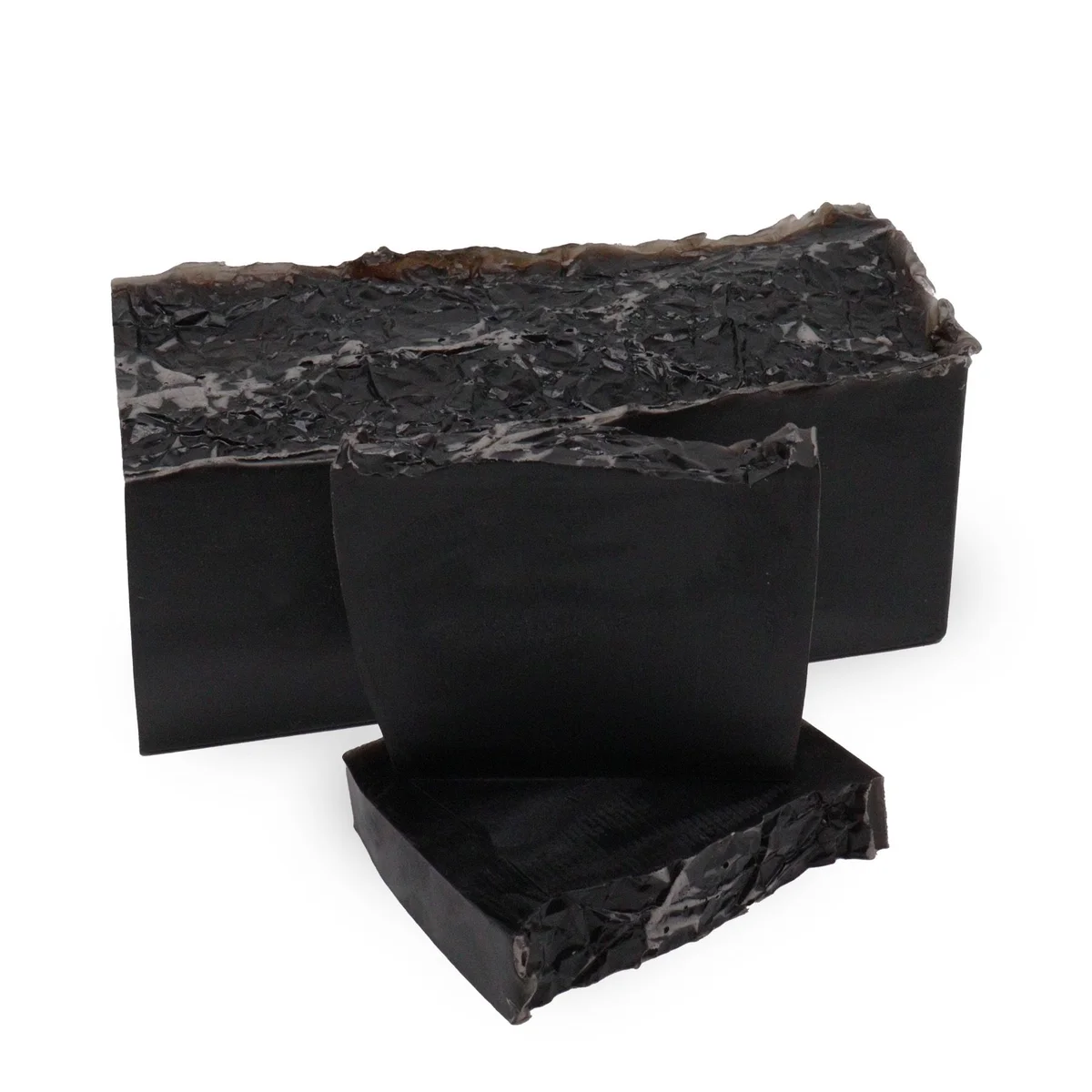 Harmony Noir soap loaf with smooth black surface and rectangular shape on a white background