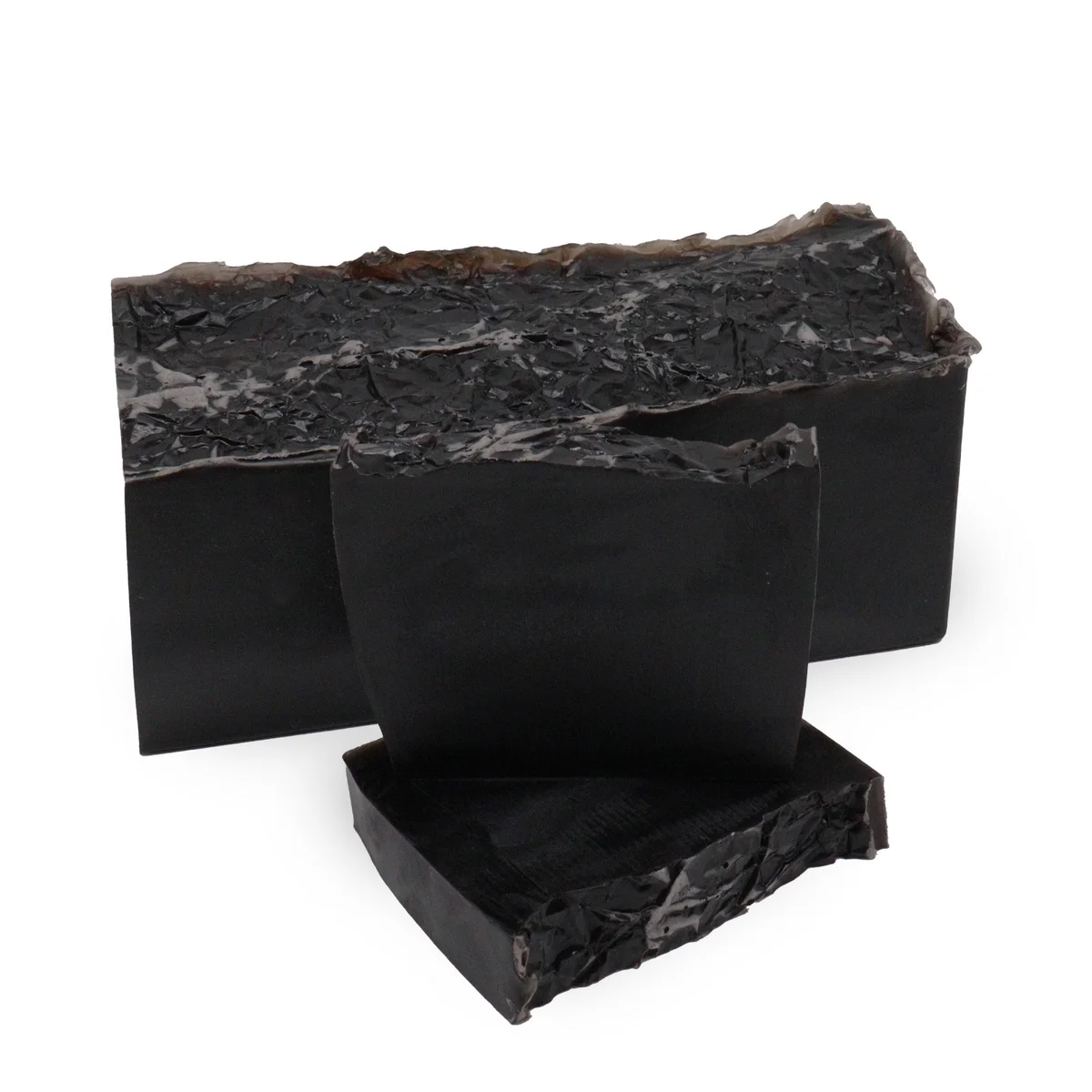 Dark Harmony Noir bath soap block loaf with smooth texture on a plain background