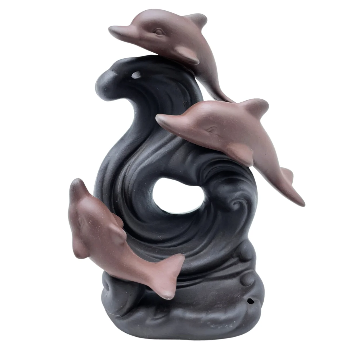 Ceramic dolphin wave incense holder with backflow design releasing smoke downwards on a dark background