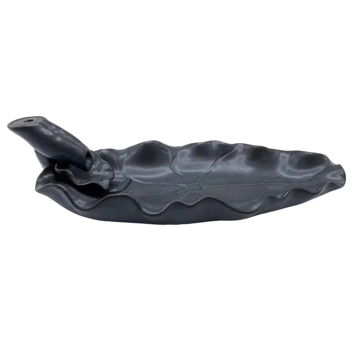 Decorative incense burner shaped like a lotus flower with backflow incense cone releasing smoke downwards