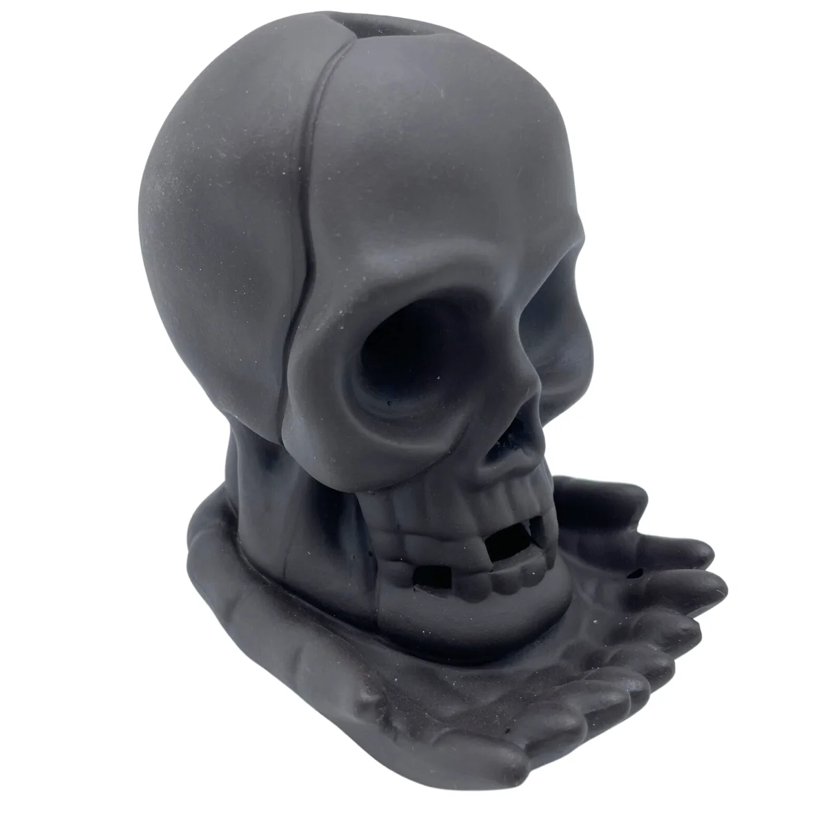 Weeping skull backflow incense burner with light glowing inside, designed for calming smoke flow effect