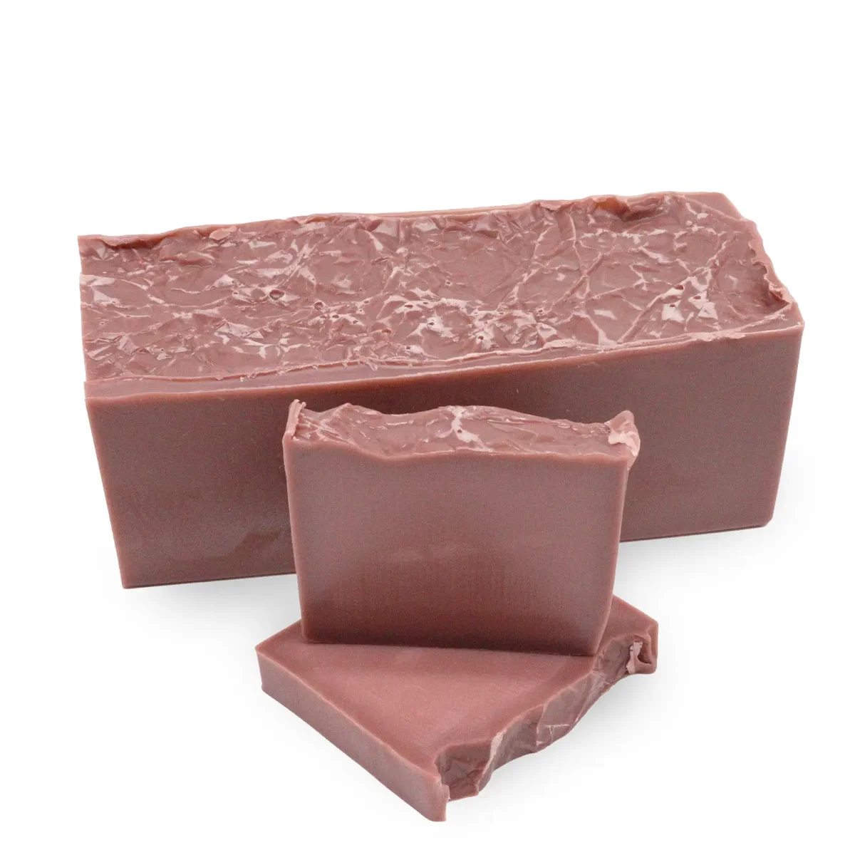 Raspberry Bliss bath soap loaf with a rich pink hue and smooth texture on a white background