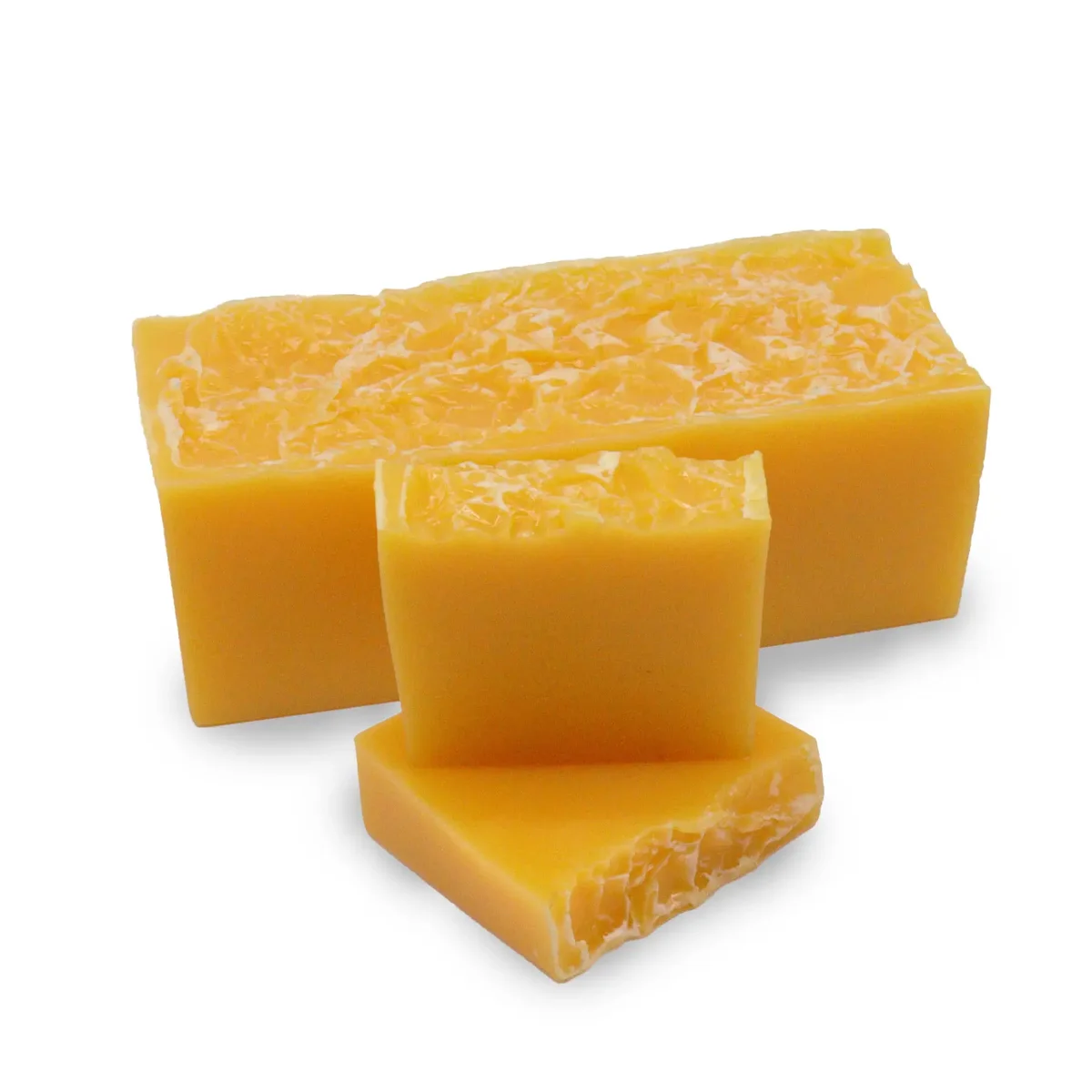Mandarin and honey natural soap loaf with smooth orange and golden layers on a white background