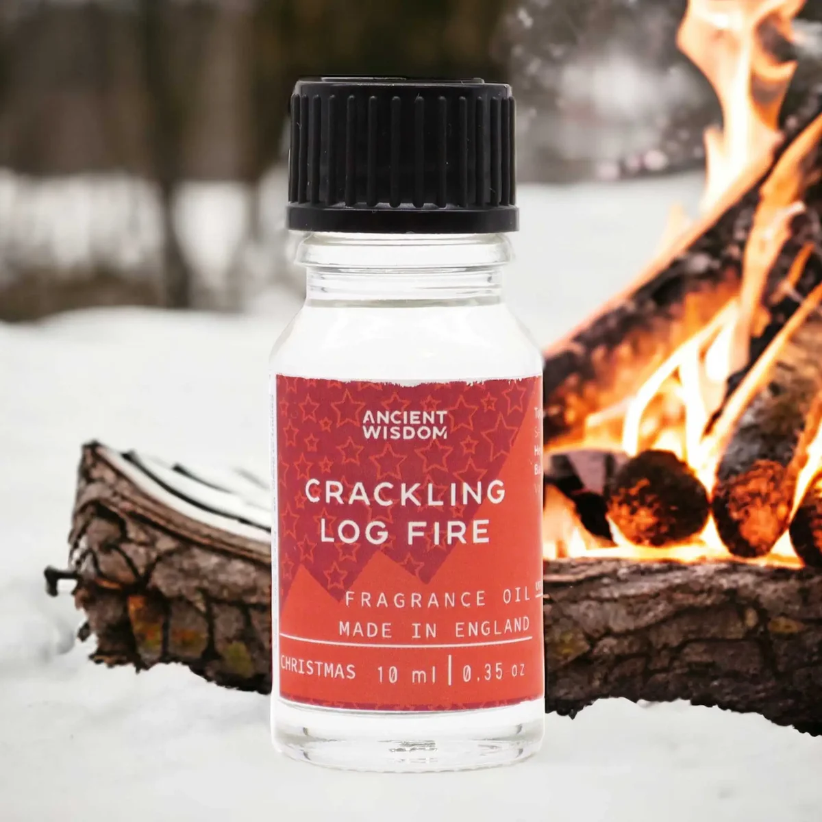 Small 10ml bottle of Crackling Log Fire fireplace fragrance oil with a label showing flames and wood logs design