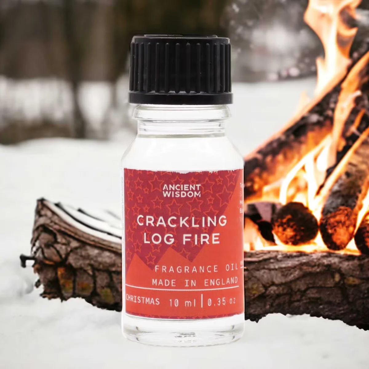 Small 10ml bottle of Crackling Log Fire home fragrance oil with a dark label and black cap on a white background