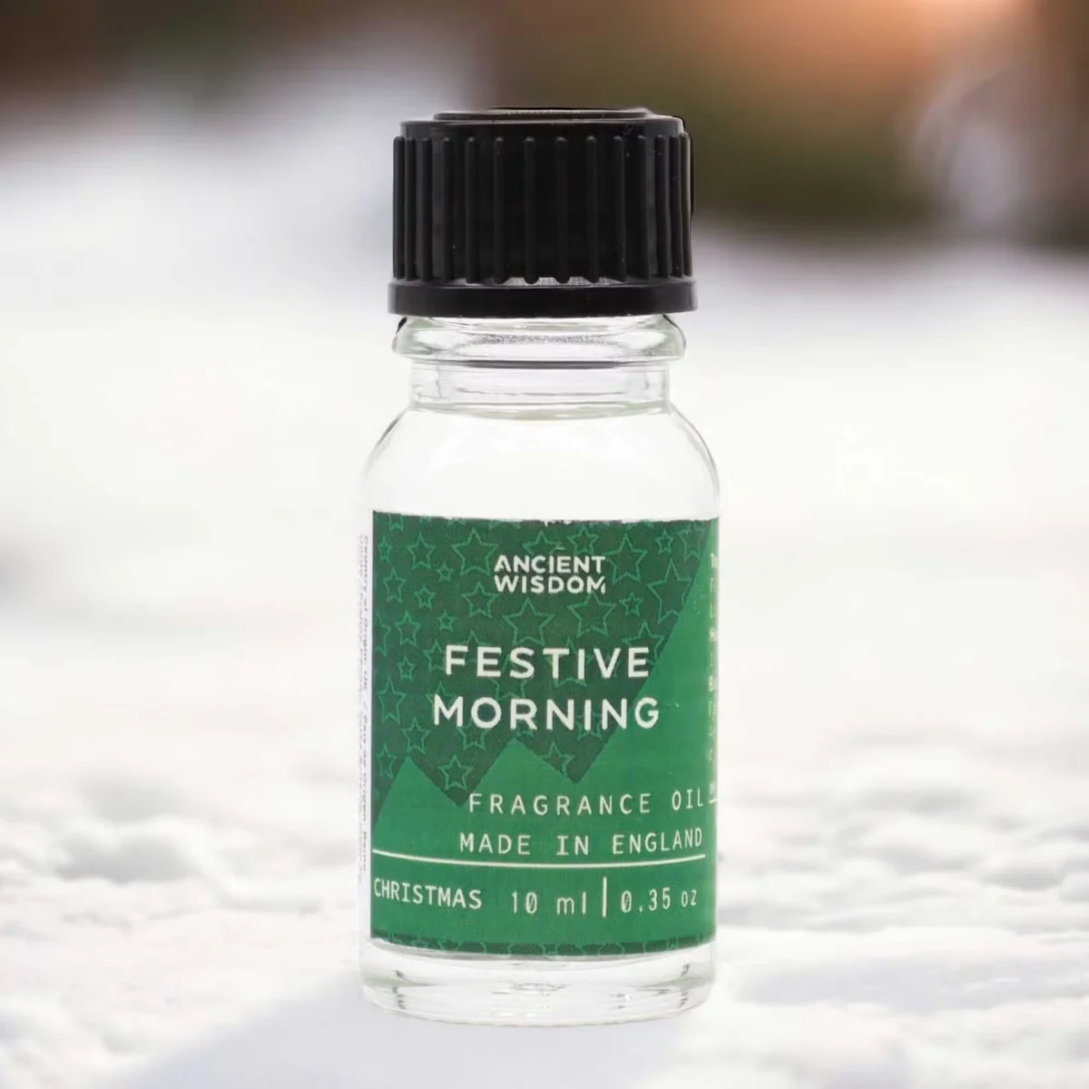 Small 10ml bottle of Festive Morning aromatherapy oil with festive-themed label on plain background