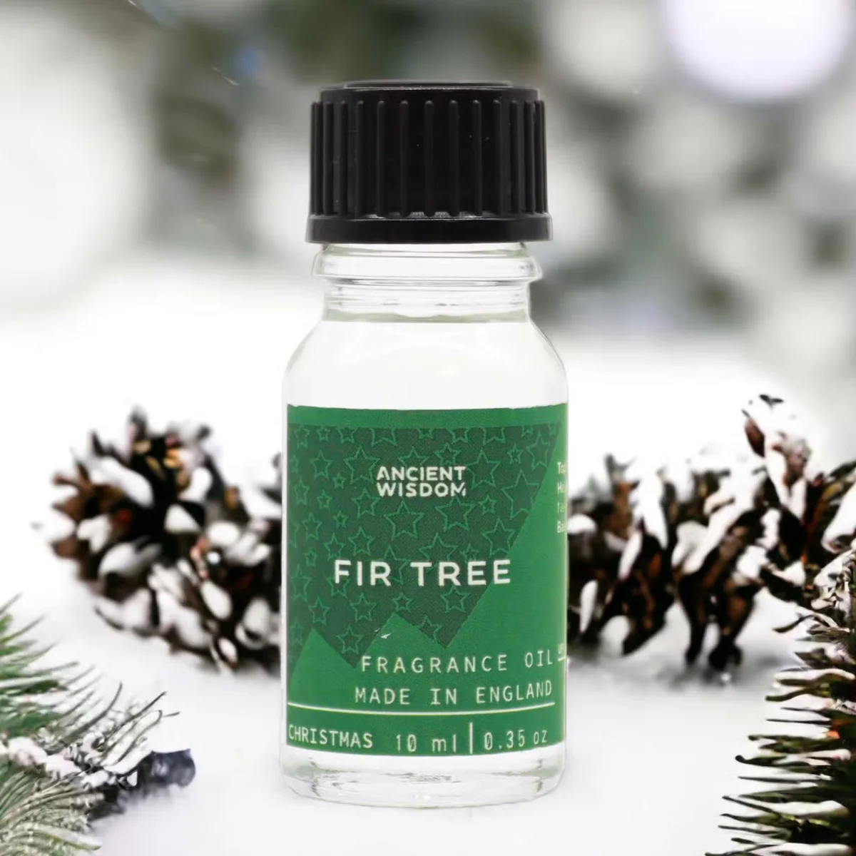 Small 10ml bottle of fir tree home fragrance oil with green label and white cap on plain background