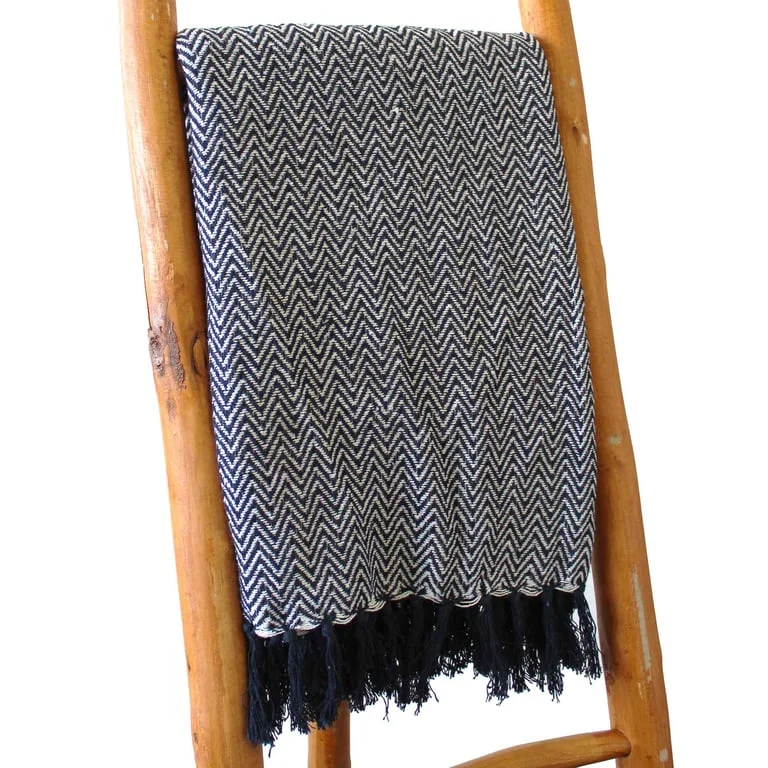 Cozy navy zigzag throw blanket in boho style, soft textured fabric.