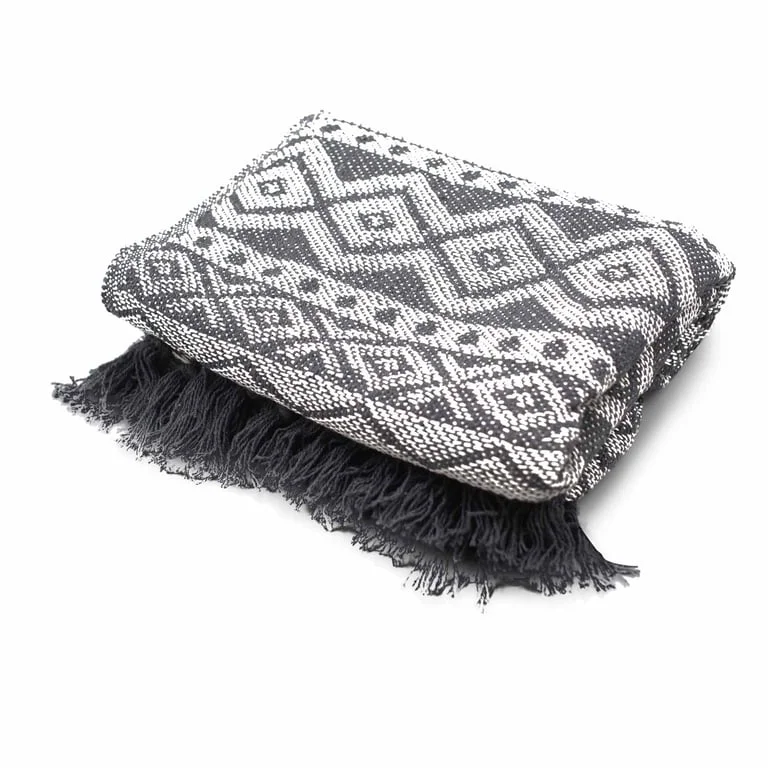 Grey geometric boho throw blanket on couch, featuring stylish home throw design