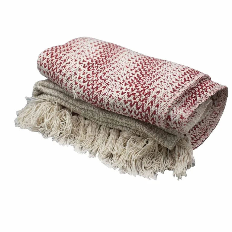 Boho style blanket in ruby two tone pattern draped softly textured across a sofa.