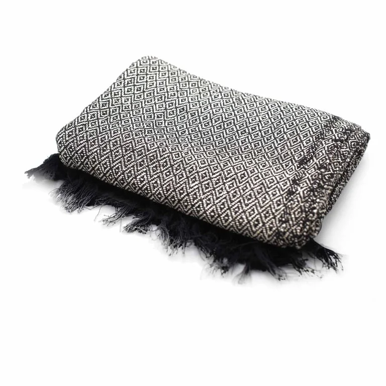 Soft charcoal boho style throw blanket displayed on a sofa, a comfortable home throw.