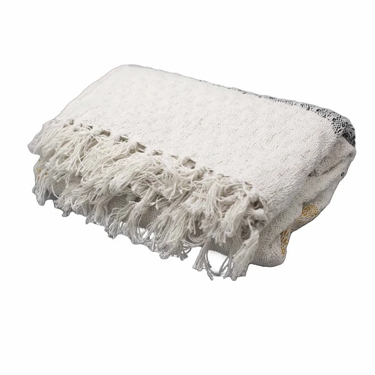 Boho comfort throw featuring mellow mattala design in warm neutral tone