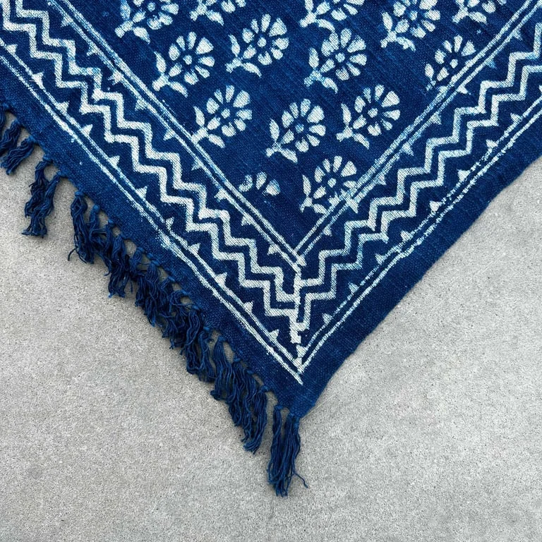 Handmade indigo throw 170x120cm, a chhota flower throw, laid over a plain sofa
