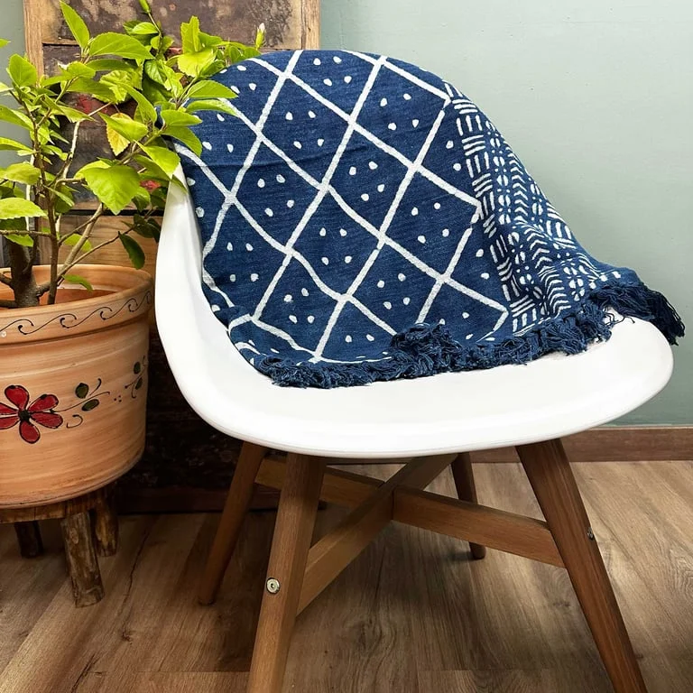 Soft canvas handmade indigo throw blanket on a sofa, tasteful midnight hue, perfect for winter decor