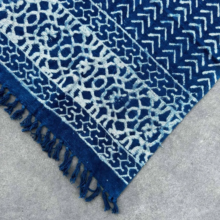 Handmade indigo throw blanket, 170x120cm throw, showing fabric and woven pattern on a sofa.