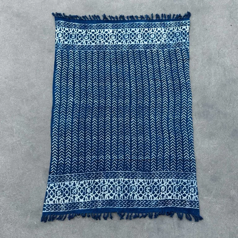 Handmade indigo throw featuring seedha arrows pattern.