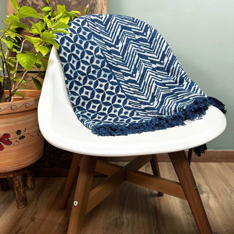 Handmade indigo throw 170x120cm with Namoona Waves pattern, draped on a sofa.