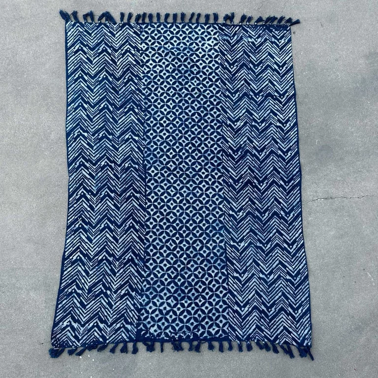 Indigo handmade decorative throw blanket 170x120cm, rich blue fabric draped on a chair, showcasing Namoona Waves design.