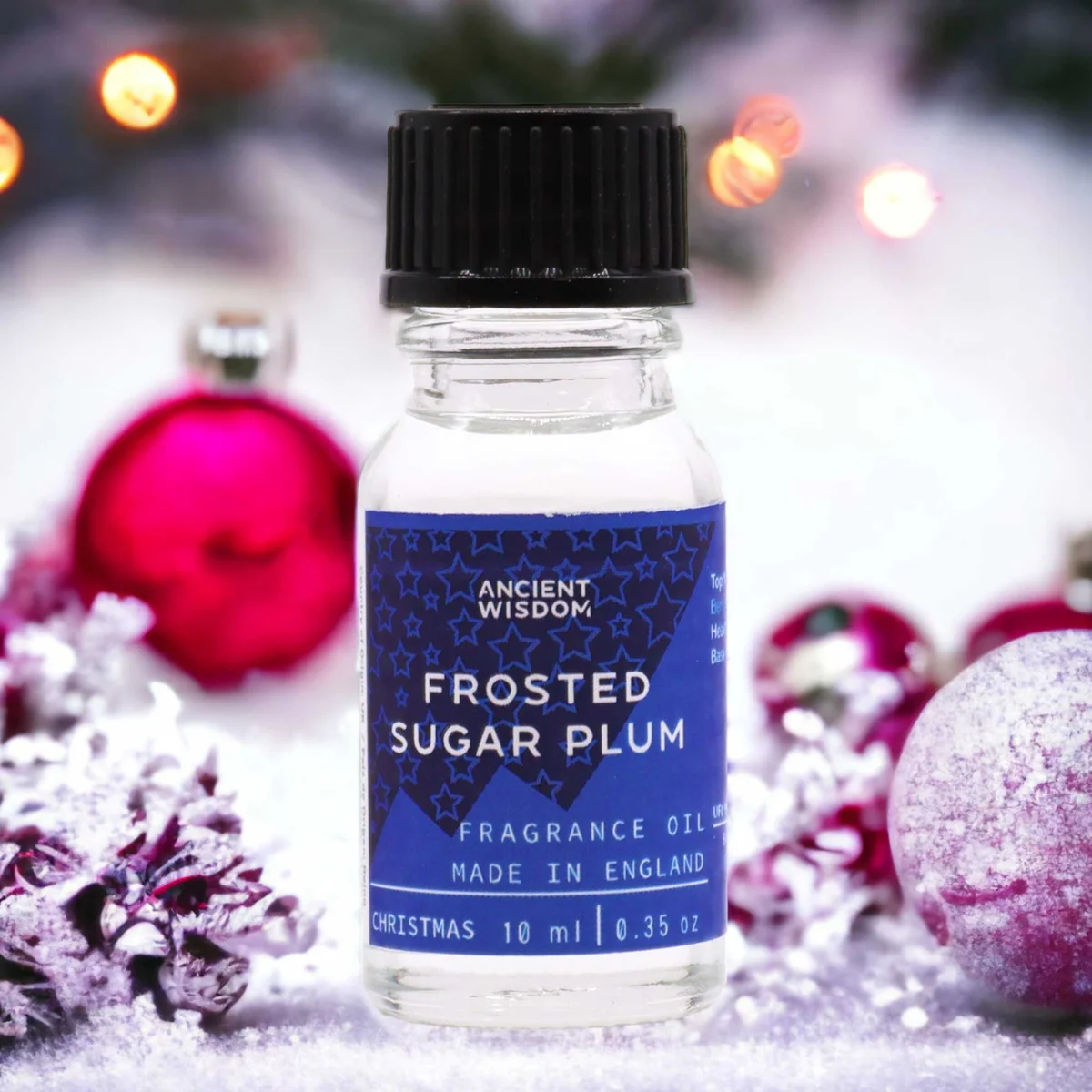 Small 10ml bottle of Frosted Sugar Plum holiday scented oil with festive label on plain white background