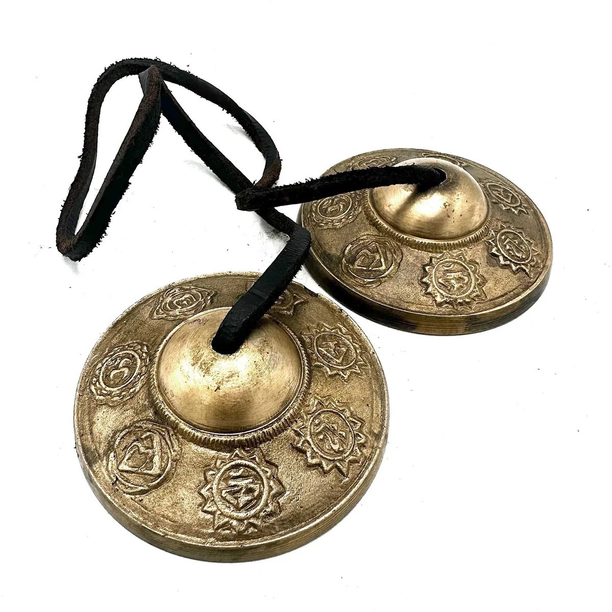Tibetan Tingsha cymbals with Seven Chakra symbols, approximately 7cm in diameter, on a white background