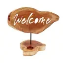 Decorative candle holder with welcome sign featuring hand‑lettered text on a simple ceramic plate.