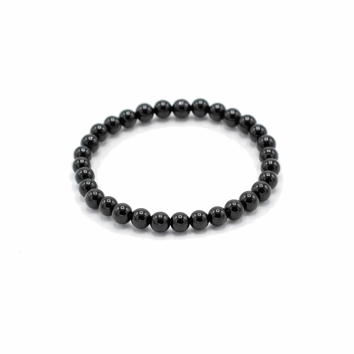 Black agate gemstone manifestation bracelet with polished round beads for protection on a white background