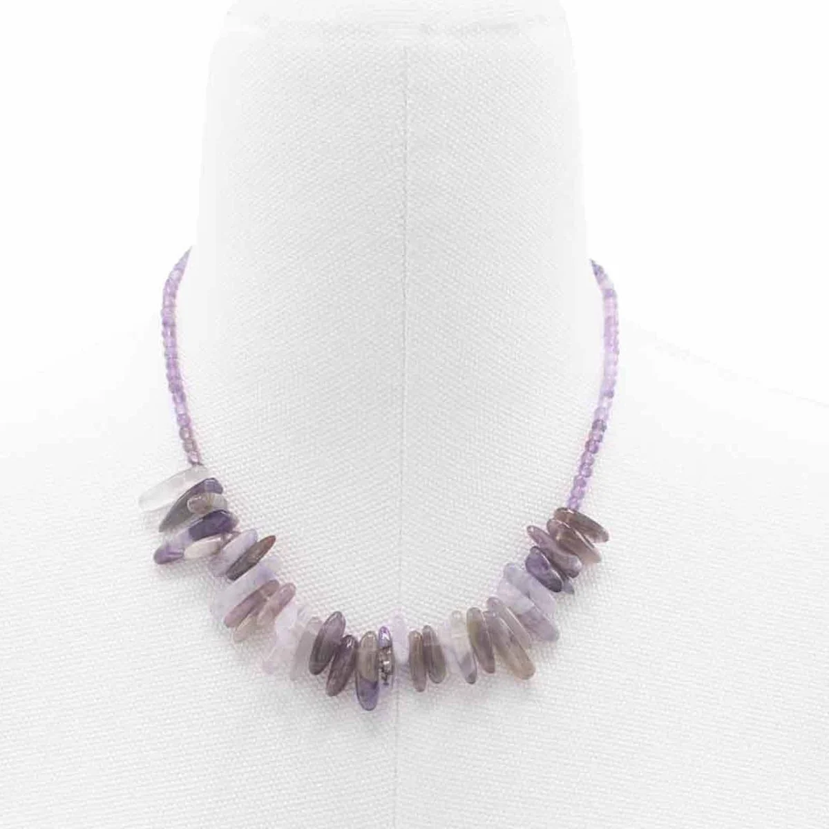 Amethyst necklace with a long gemstone suspended on a delicate chain.