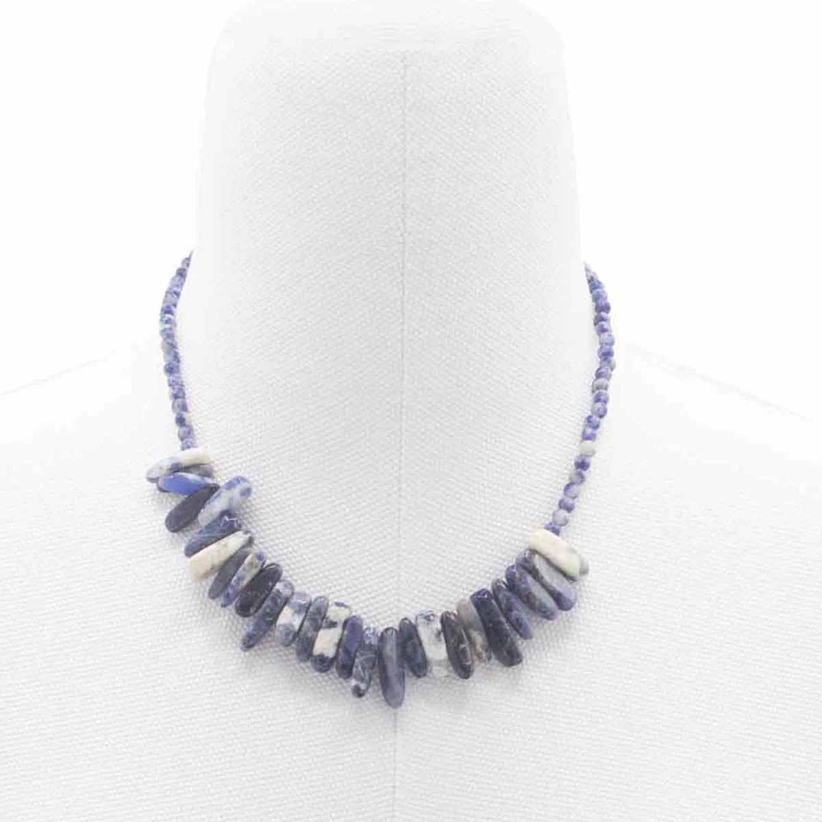 Sodalite gemstone necklace featuring a flat octagonal stone on a silver chain, displaying soft blue and white speckled surface.