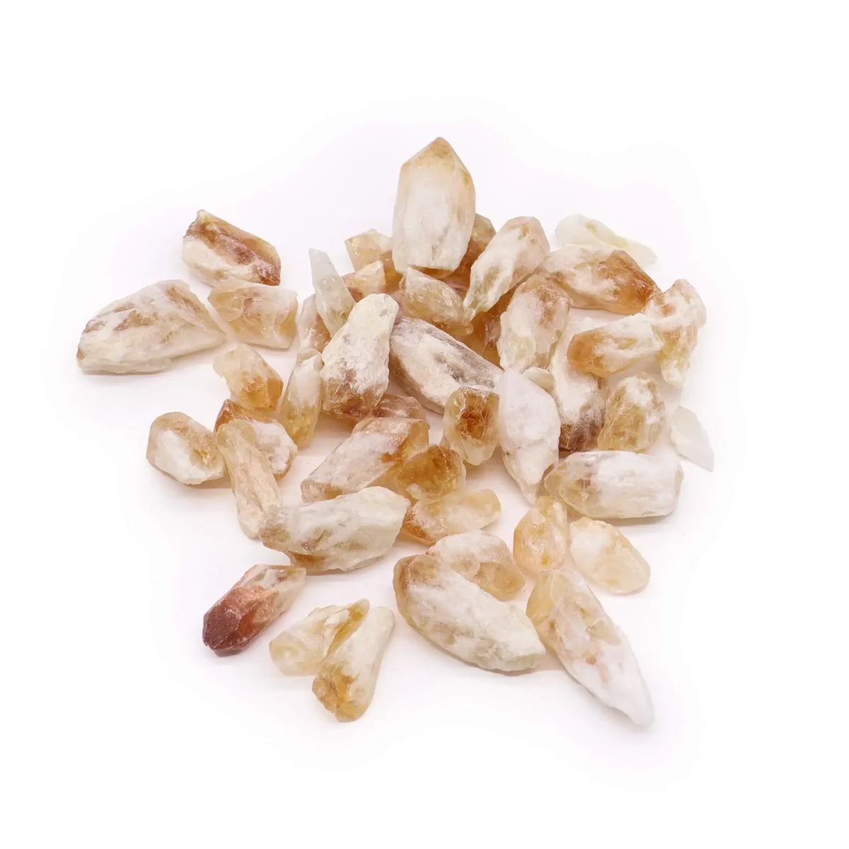 Pile of raw citrine crystals rough points weighing 500 grams on a white background