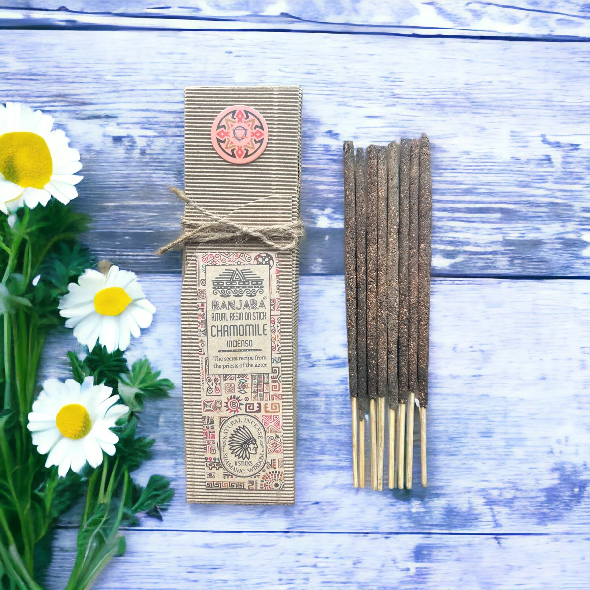 Chamomile incense stick burning with gentle smoke rising from the ritual resin on stick product packaging