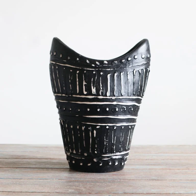 Chocolate coloured vase featuring swirling pattern on a slender silhouette.