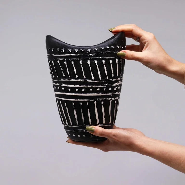 Stylish swirl vase in rich chocolate shade, tilted slightly, showcasing its graceful spiral shape and smooth surface.