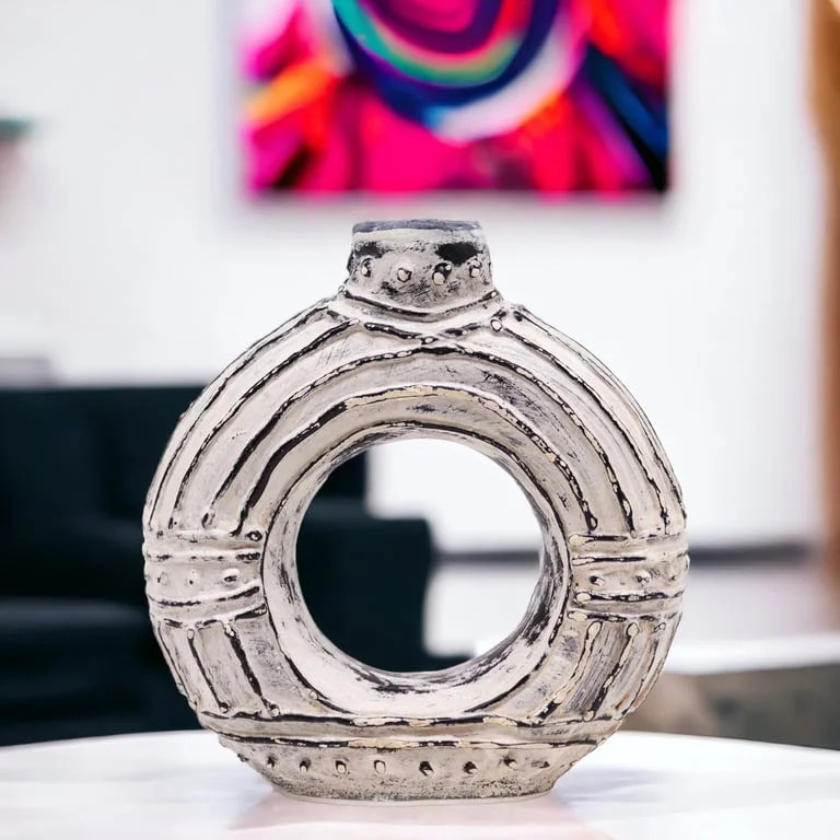 Cream round donut shaped vase showing a circular, elevated rim with a hollow centre, 18cm tall, a unique donut shaped vase