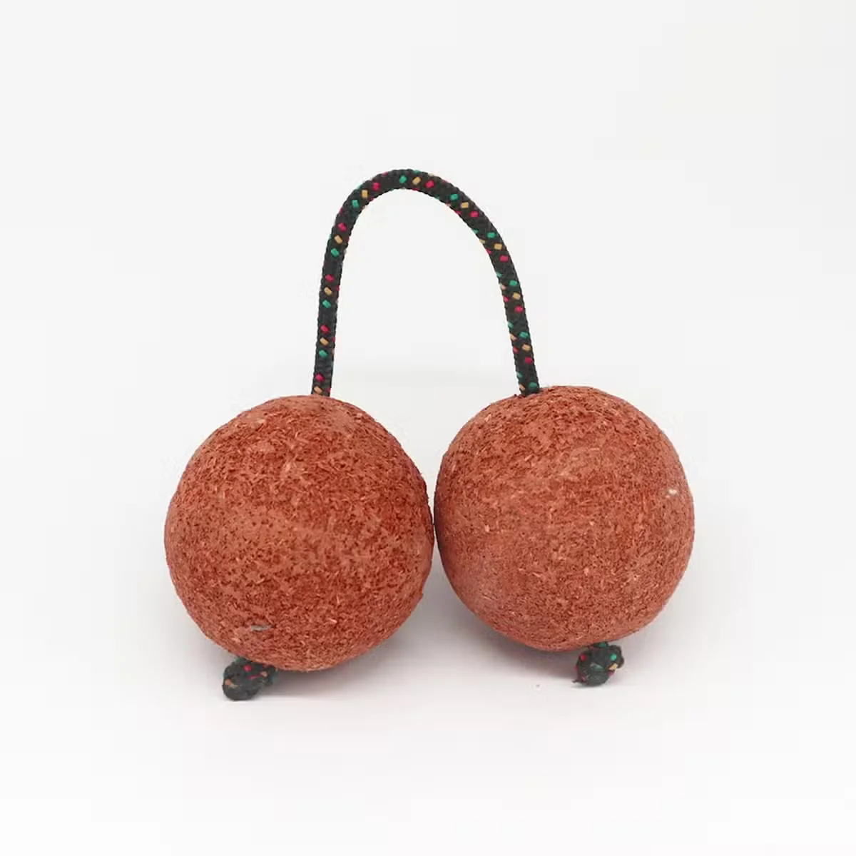 Beach style shaker Kashaka with natural materials and traditional design, shown against a plain background