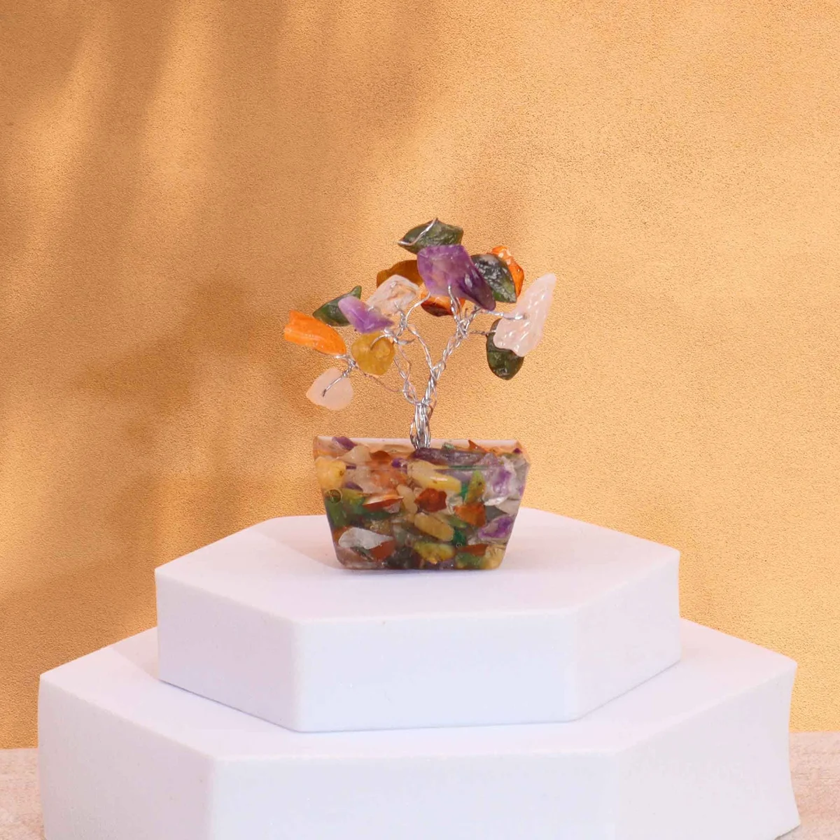 Mini gemstone tree with 15 multi-colored stones on a white orgonite base, decorative and compact.