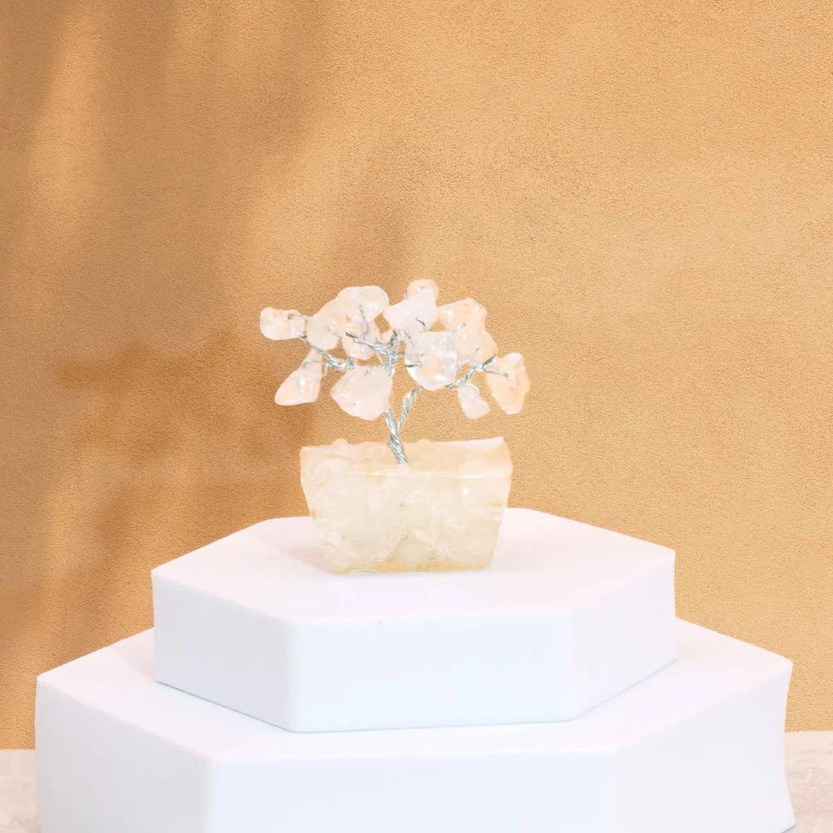 Mini decorative gemstone tree with 15 rock quartz stones on a white orgonite base against a plain background