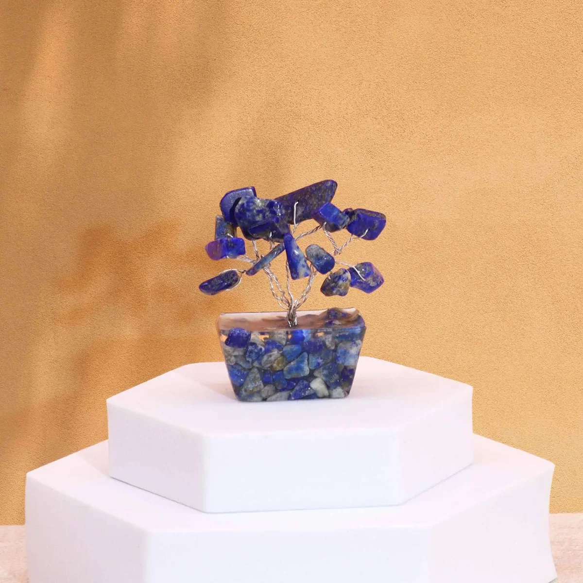 Mini sodalite gemstone tree with 15 stones on a black orgonite base displayed on a white background