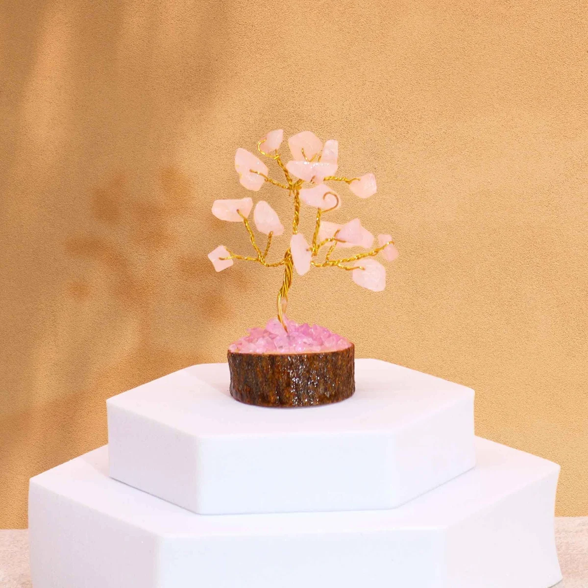 Mini gemstone tree with 15 rose quartz stones on a wooden base displayed on a white background
