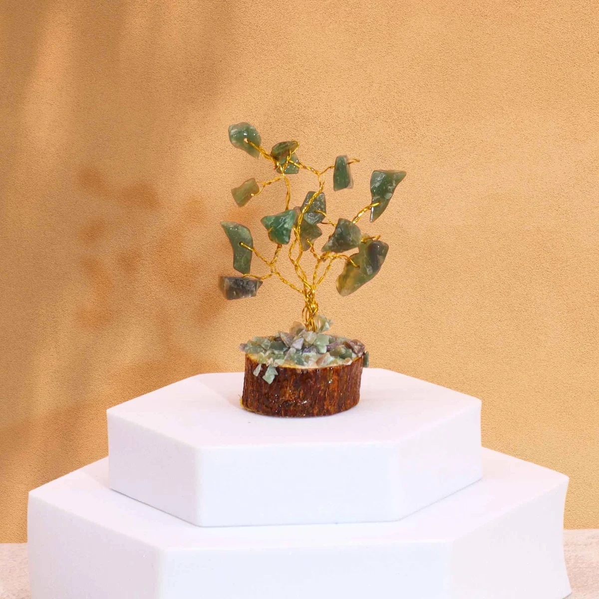 Mini gemstone tree ornament with 15 green aventurine stones on a wooden base against a white background