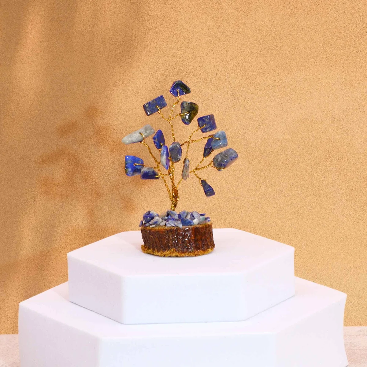 Mini sodalite gemstone tree with 15 blue stones on a natural wood base for decorative use