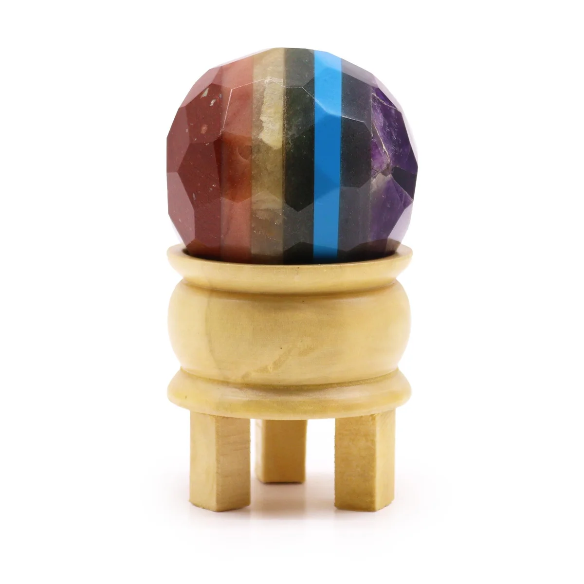 Faceted gemstone seven chakra healing ball on a black stand showing vibrant multicolored stones