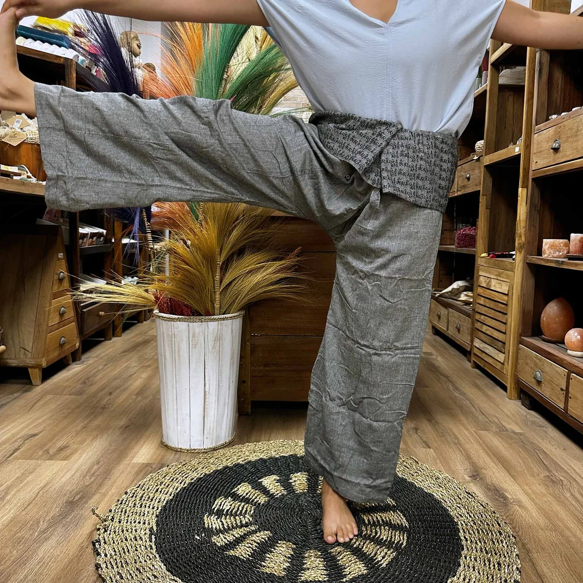 Grey yoga pants featuring a detailed mandala mantra design, styled as Thai fisherman trousers for festivals and comfort