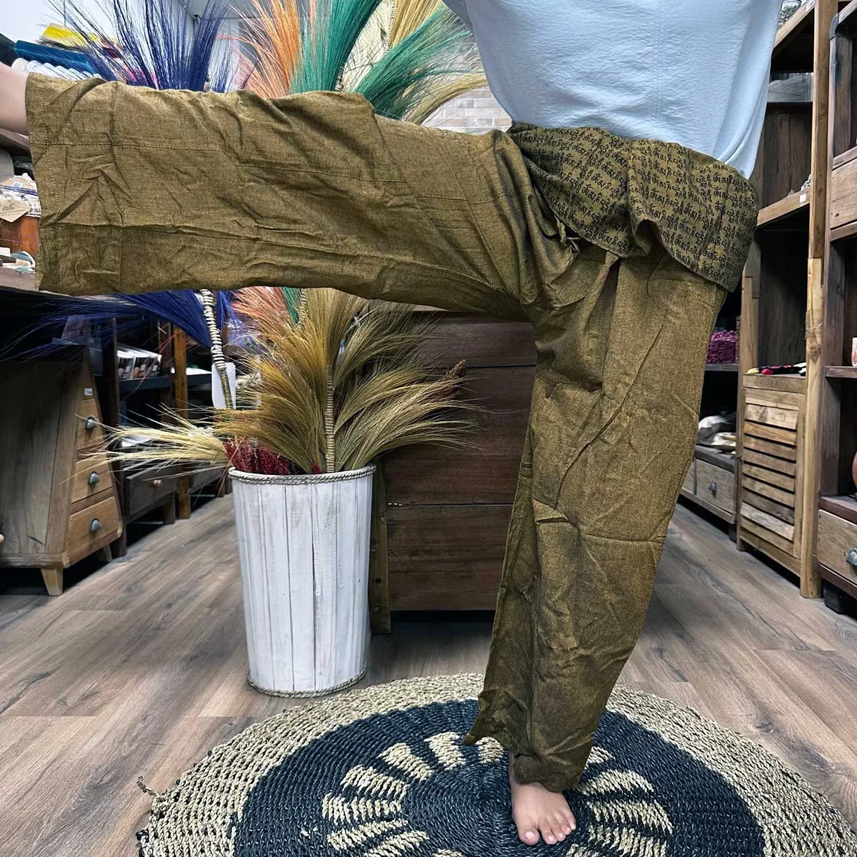 Orange yoga trousers with Thai fisherman style and mandala mantra design, loose fit for yoga and festivals