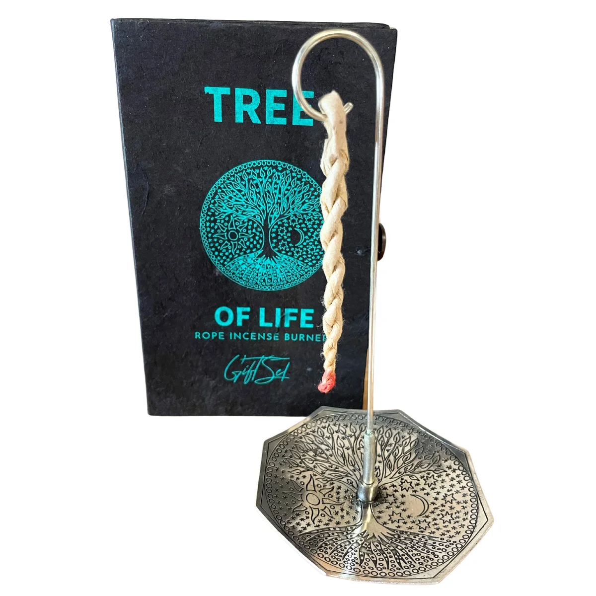 Silver plated holder with intricate tree of life design holding burning rope incense in tree of life incense set