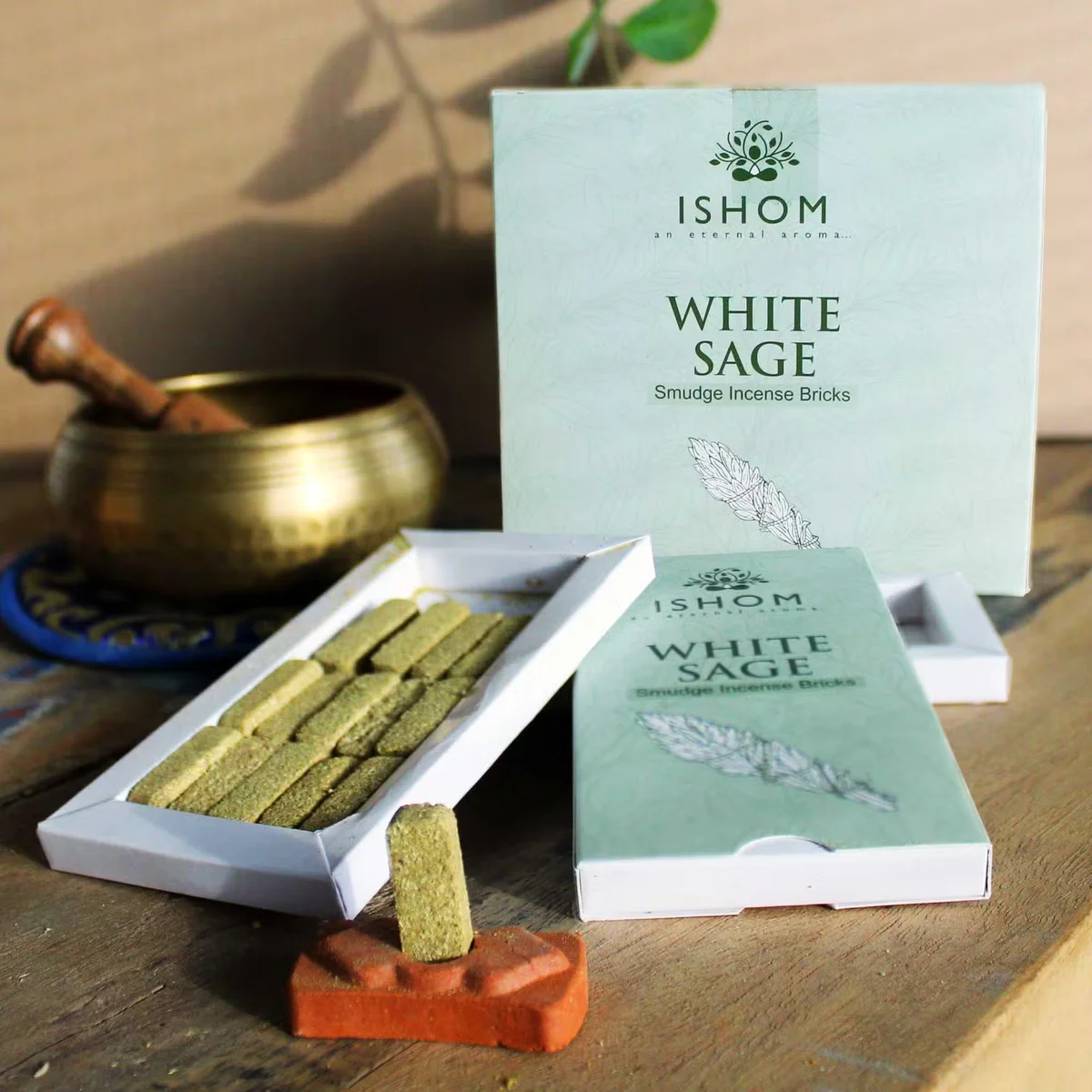 Pack of 15 white sage smudge bricks arranged with a ceramic incense burner set on a white background
