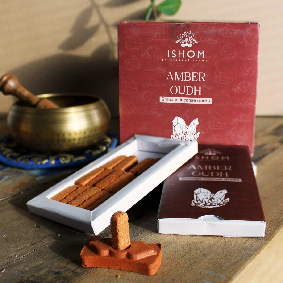 Pack of incense bricks with 15 natural amber wood smudge bricks and a wooden burner on a white background