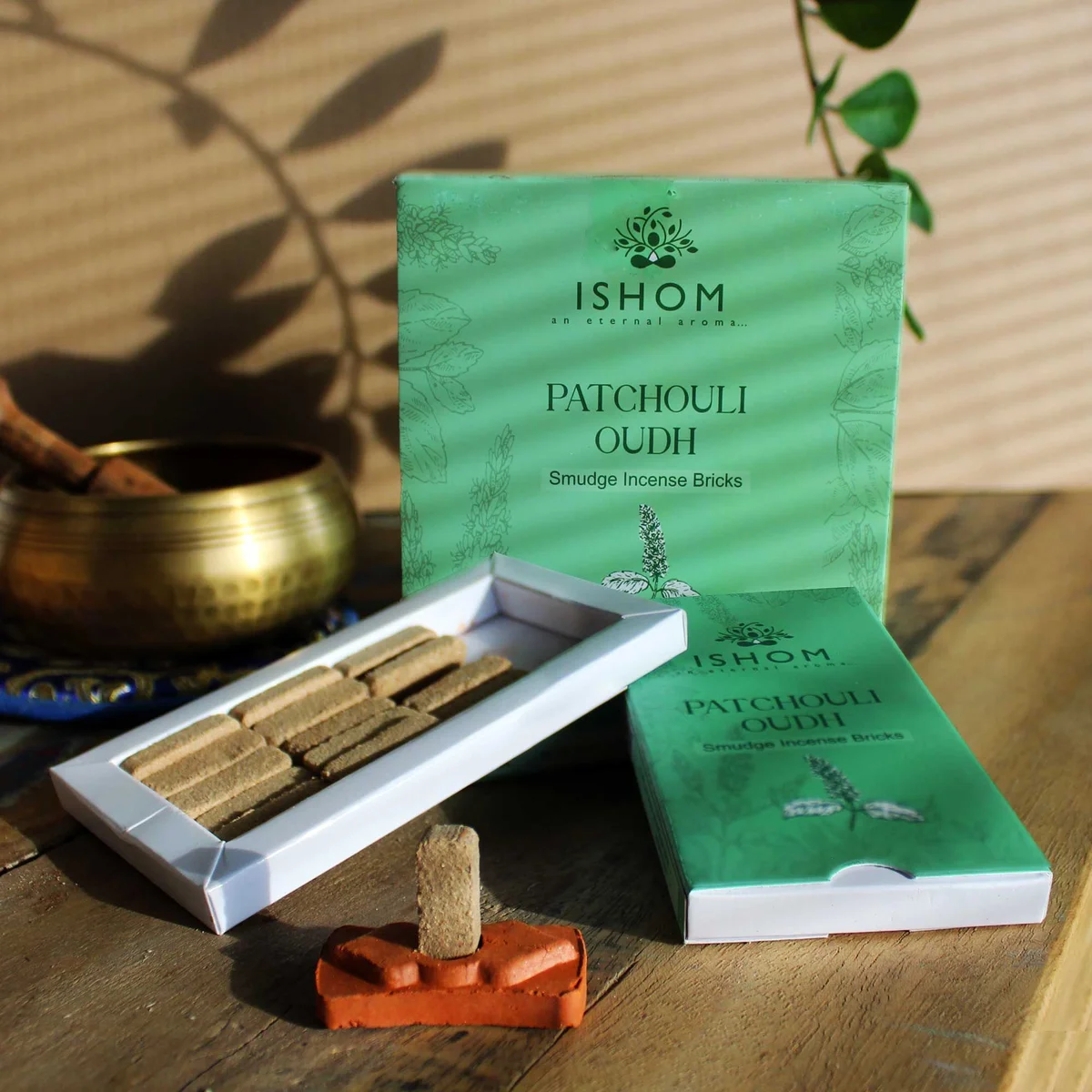 Pack of 15 natural incense smudge bricks with a wooden burner, featuring patchouli scent on a white background