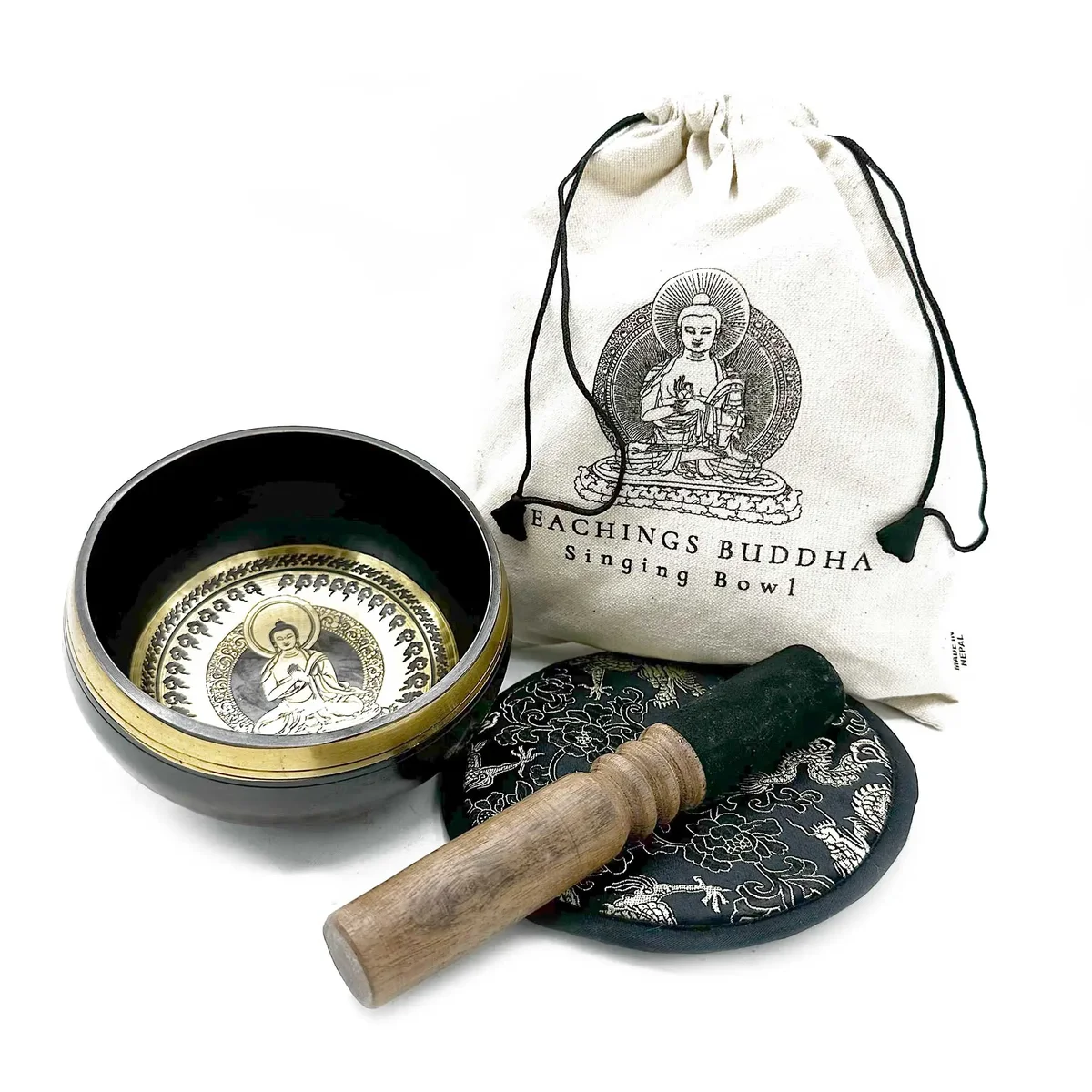 Hand beaten singing bowl 14cm with engraved Buddha teachings, wooden striker, and cushion gift set on white background
