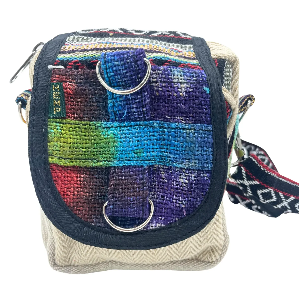 Tiedye hemp bag with adjustable strap and flap closure in natural earthy tones on plain background